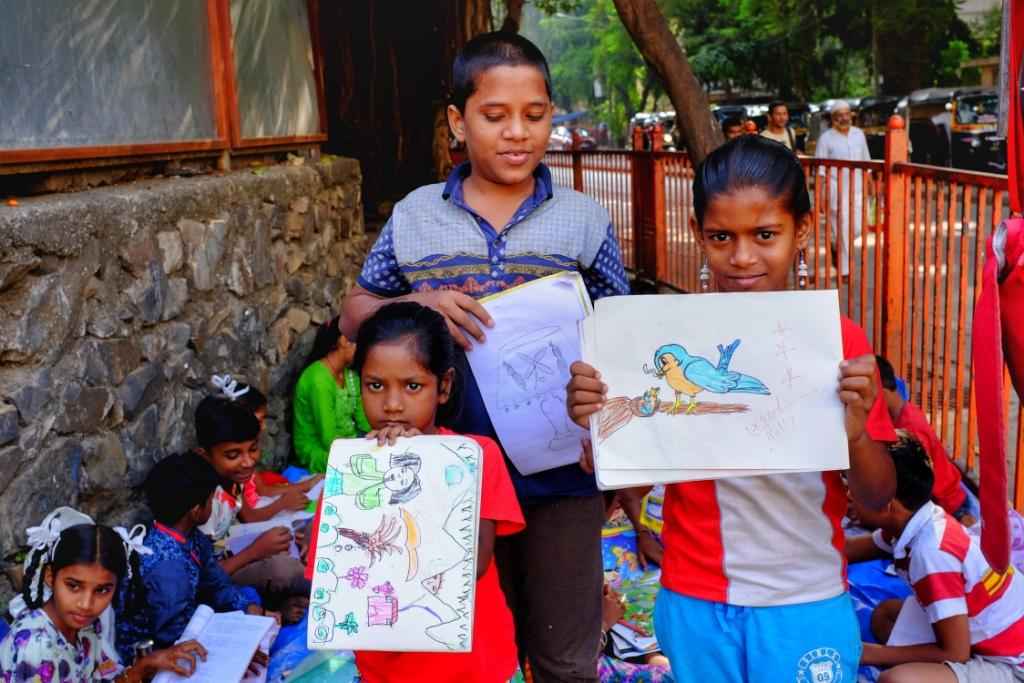 Students with their drawings