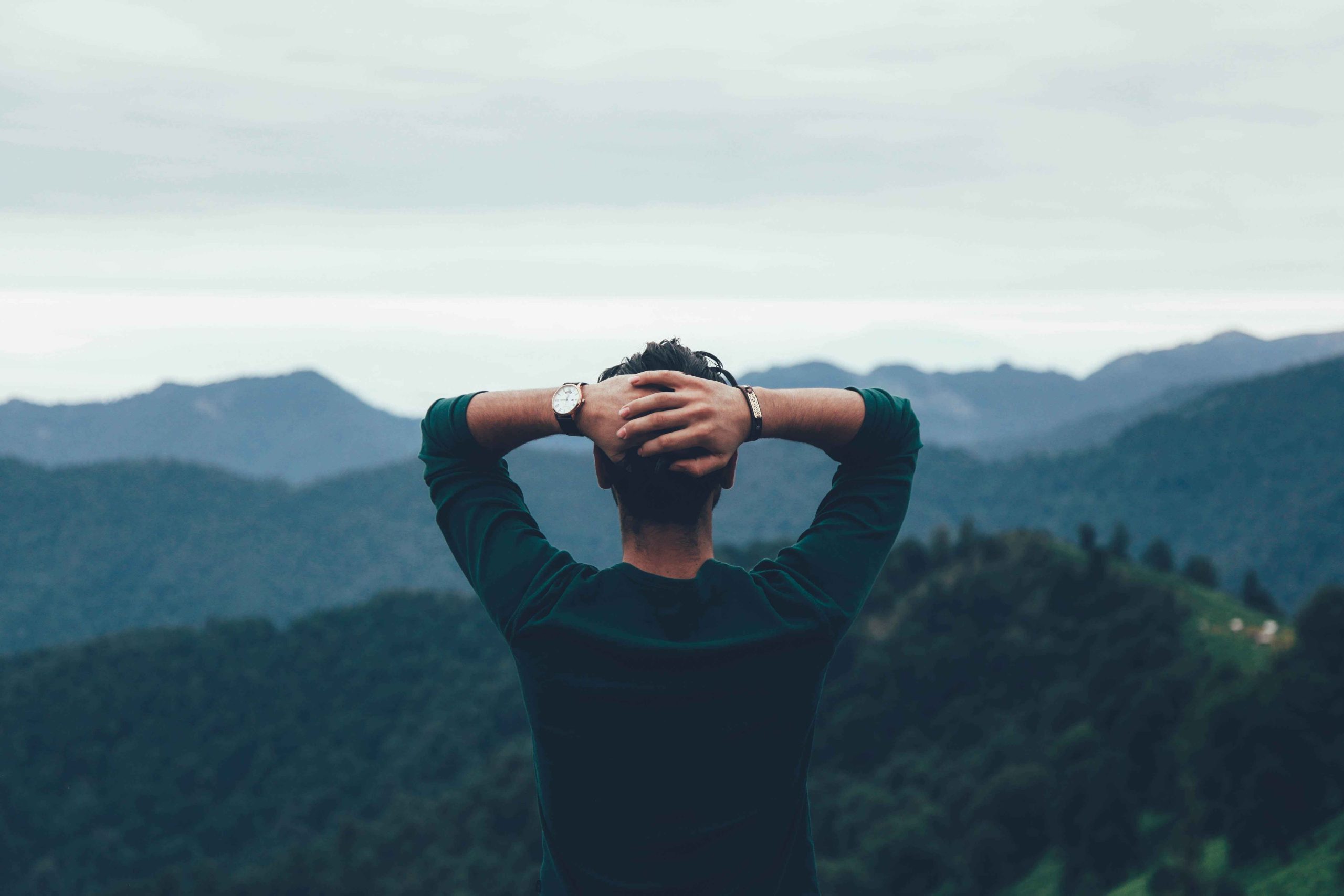 man looking at mountains