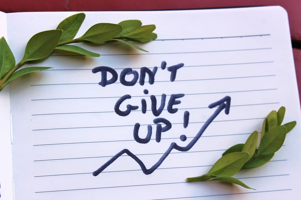 Don’t give up quote written in book