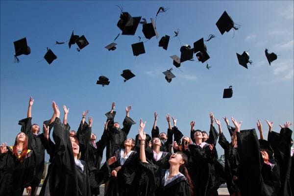 Students flying graduation caps