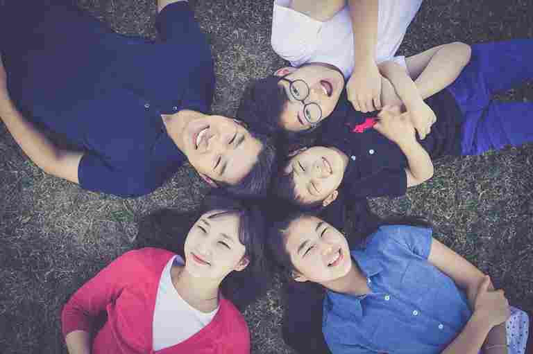 Friends lying in grass