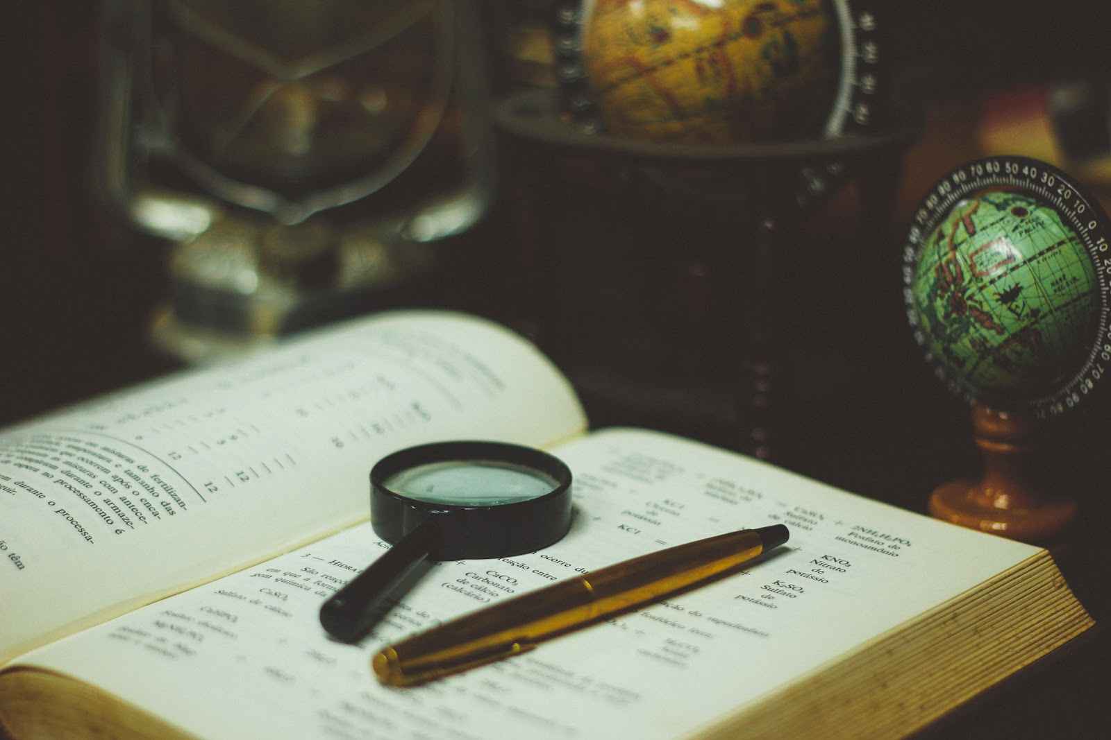 Magnifying glass & pen on a book