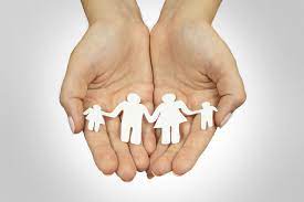 Hands holding paper cutouts of a family, symbolizing unity and love. A heartfelt representation of familial bonds and togetherness.
