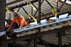 contract engineer working on a wooden beam