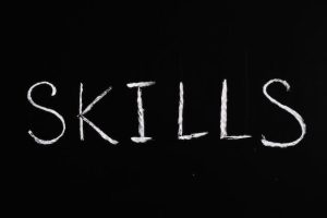 The word "skills" written in chalk on a blackboard, representing the importance of acquiring knowledge and abilities.
