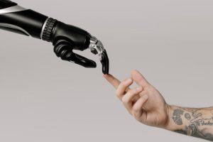 A robotic hand reaching out to touch a person's hand, showcasing the merging of technology and humanity.
