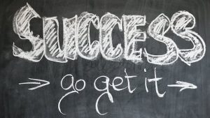 Success written on a blackboard. Motivational message to go after your goals.