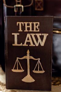 A photo of a law book with a gavel on top, symbolizing justice and legal knowledge.
