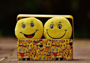Two yellow smiley faces in a box, radiating happiness and positivity. Spread the joy! 