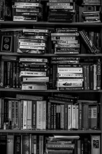 A monochrome picture of a bookshelf filled with books, showcasing a timeless collection of knowledge.