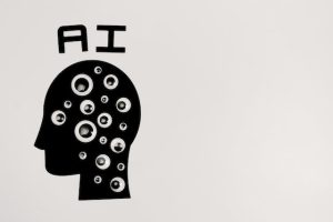 A black and white image of a head with eyes and the word "AI" written on it.