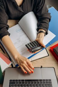  A woman calculating taxes on a calculator.