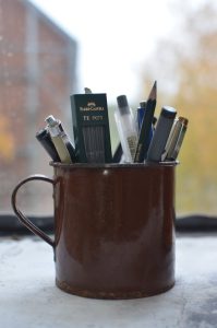A mug filled with pens and pencils, ready for work or creativity.