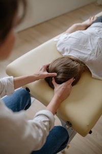 A woman receiving a massage from a therapist in a serene professional setting.