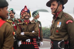Indian army soldiers in uniform and hats, standing tall with pride and determination.