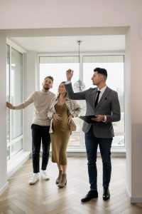 real estate consultant showcasing homes to the couple