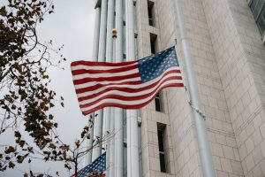 American flag waving in front of White House.