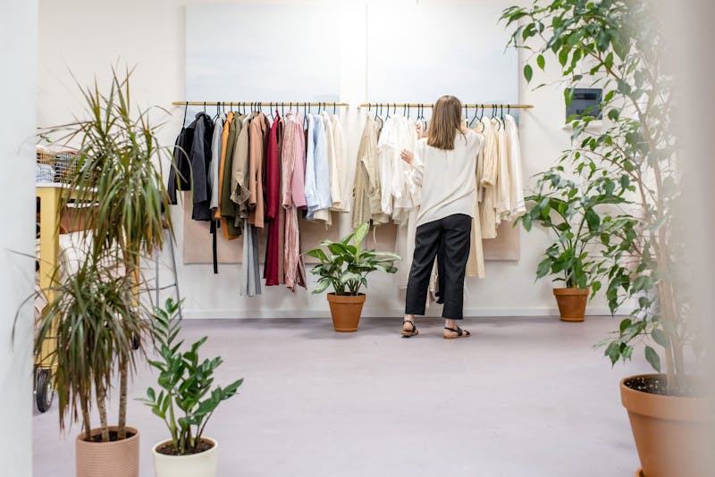 A professional organiser setting up a wardrobe of clothes